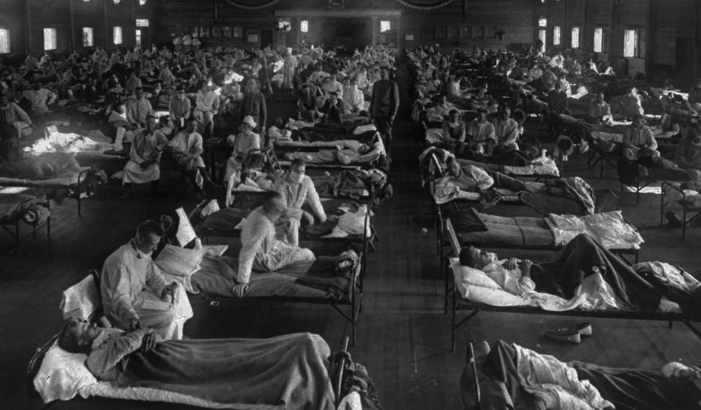 Žrtve gripe v zasilni bolnišnici blizu Campa Funston — danes Fort Riley — v Kansasu leta 1918.Fotografija: AP Photo/National Museum of Health.